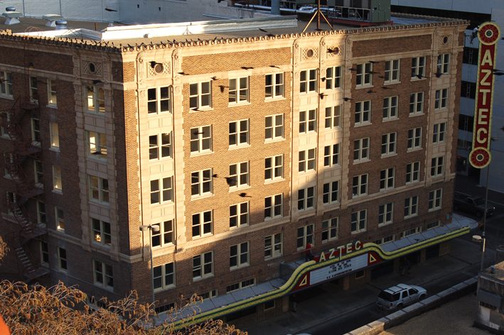 The Aztec Theatre and its blade sign at dusk